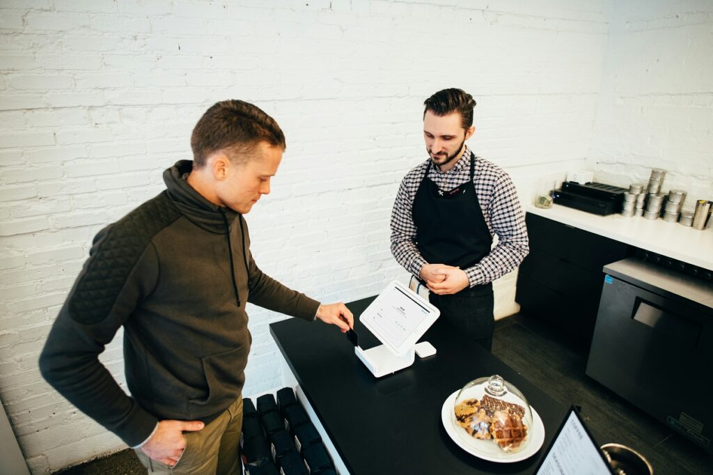 person making digital payment on laptop representing micro transactions